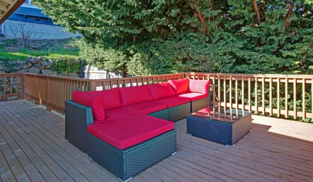 Spacious walkout deck with black and red sofa