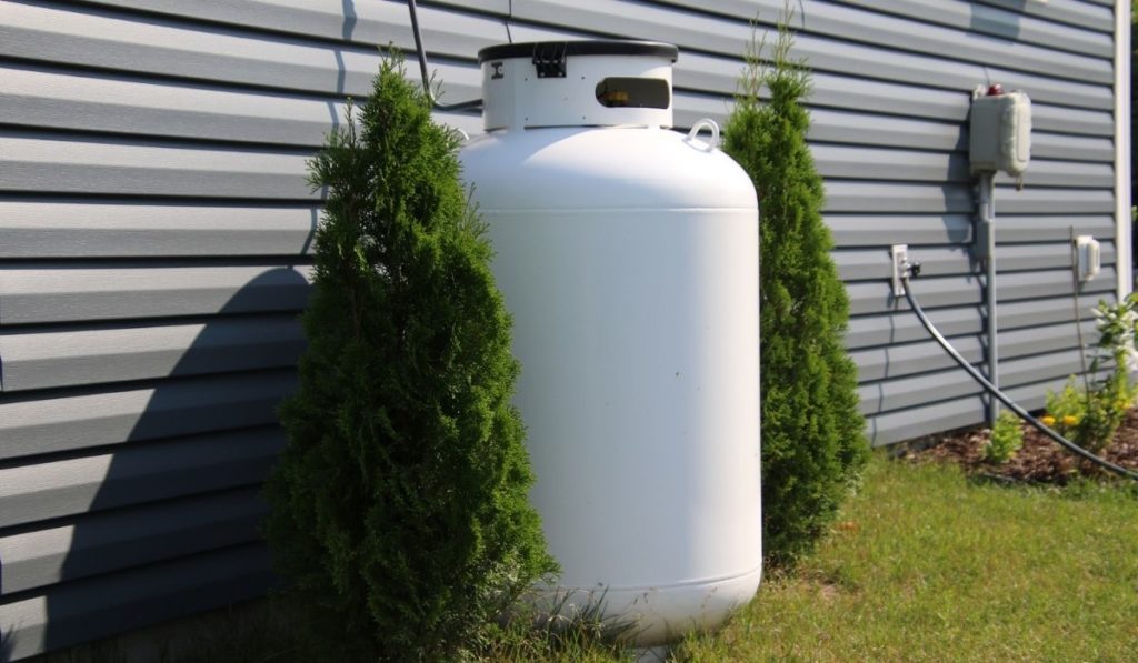 A large propane tank on the side of a house