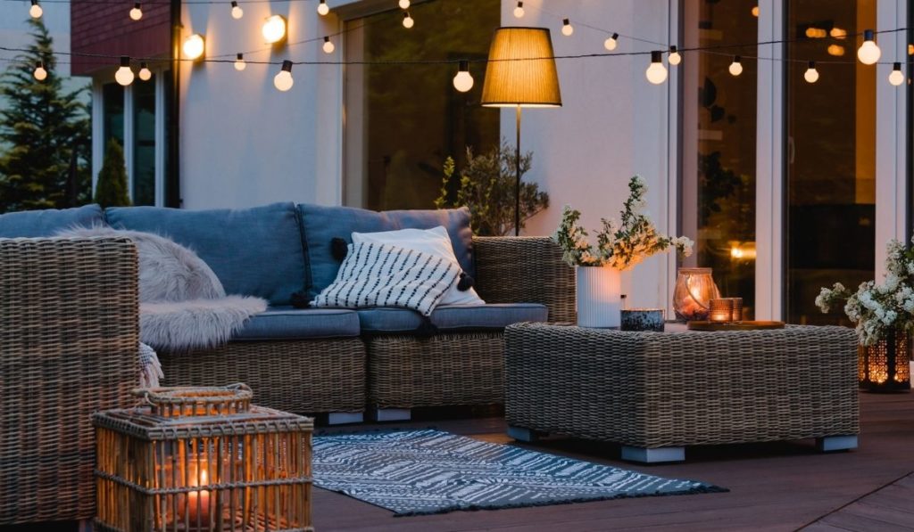 Evening on the patio of beautiful suburban house with lights in the garden garden