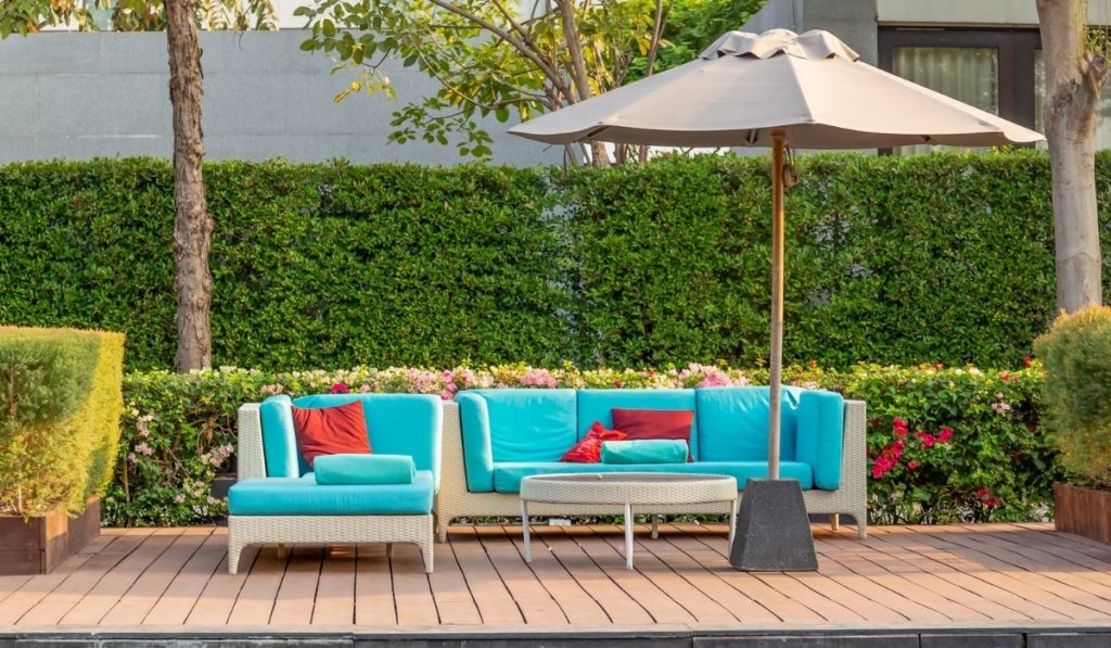 Large terrace patio with rattan furniture in the garden with umbrella