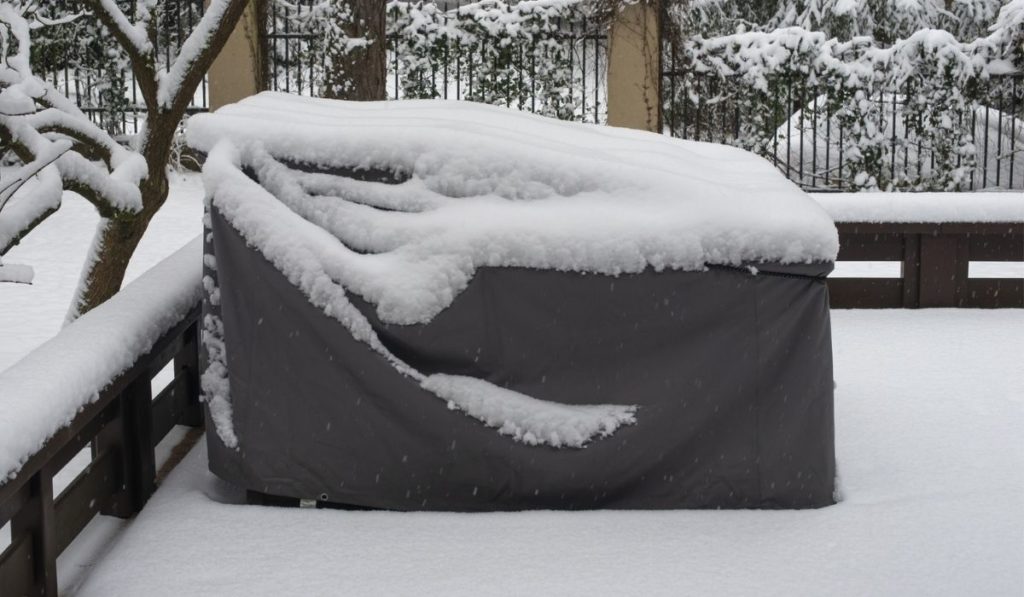 Patio furniture Cover protecting outdoor furniture from snow 