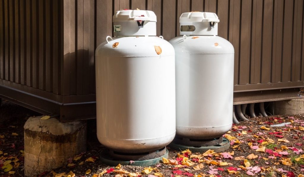 White propane tanks at the back of a metal hut