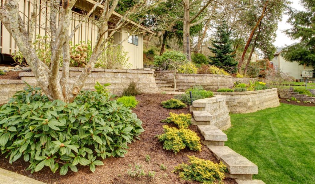 Spring Landscape with retaining walls and garage
