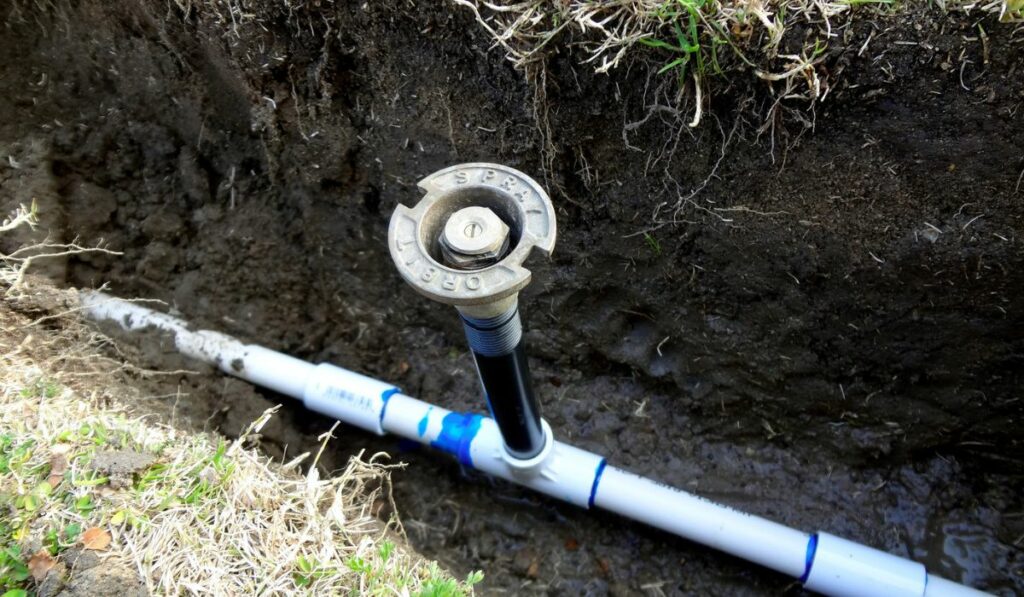 Exposed sprinkler in open trench