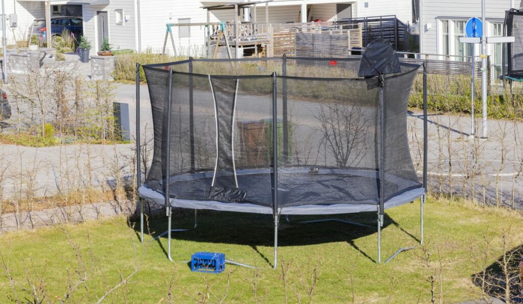 Beautiful view of trampoline with protective net installed in yard