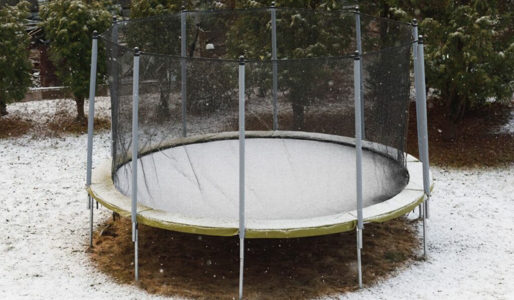 Trampoline with snow at winter time