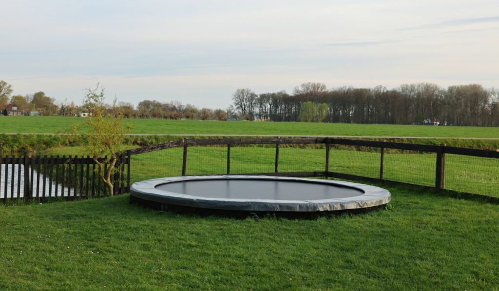Beautiful view of green lawn with big trampoline